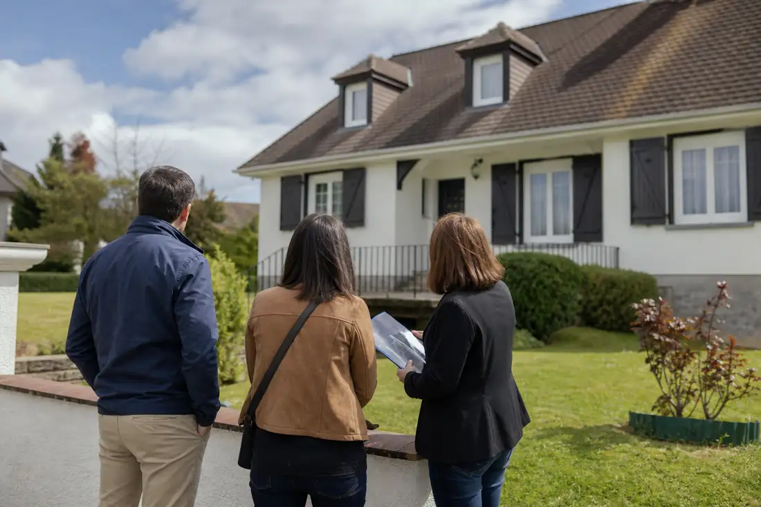 Maison individuelle avec jardin dans un secteur résidentiel de Morlaàs, visitée par des acquéreurs accompagnés.